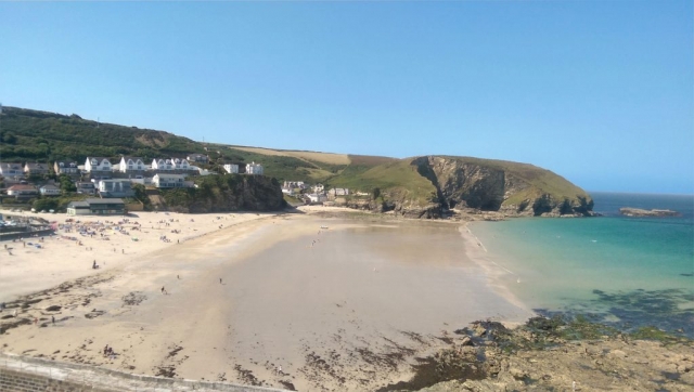 View of Portreath Beach with blue skies and clear blue water